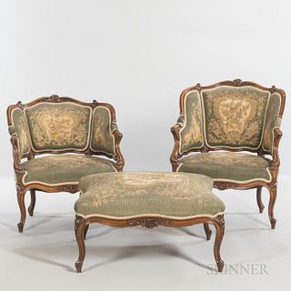 Louis XVI-style Walnut Seating Suite, with needlework upholstery, comprising two armchairs, ht. 29 1/2, wd. 27, dp. 21, and a footstool