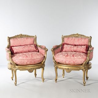 Pair of Louis XVI-style Bergeres, each with a gilded frame and pink silk upholstery, ht. 34, wd. 40, dp. 17 in.