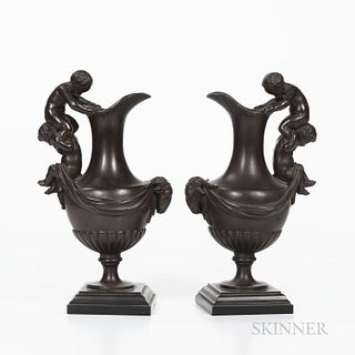 Pair of Maison Alphonse Giroux Bronze Figural Ewers, France, 19th century, each with handle modeled as a putti resting on the shoulders