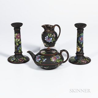 Four Wedgwood Enamel Decorated Black Basalt Items, England, 19th century, each with polychrome enameled flowers, a pair of candlesticks