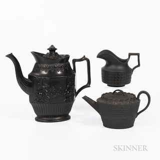 Three Black Basalt Tea Wares, England, 19th century, a marked Wedgwood basketweave engine-turned teapot and cover, lg. 8 1/2; a marked