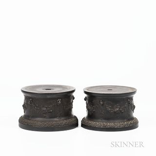 Two Wedgwood Black Basalt Drum Bases, England, early 19th century, cylindrical shape with fruiting grapevine festoons terminating at le