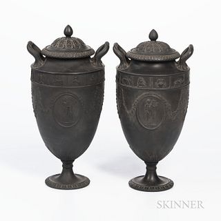 Two Wedgwood Black Basalt Zodiac Vases and Cover, England, c. 1880, a band of astrological motifs above floral festoons and oval medall