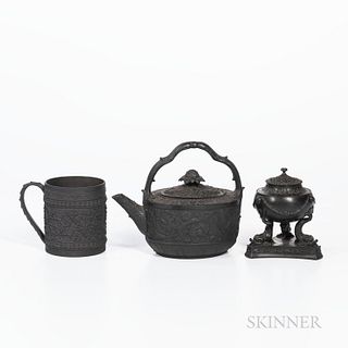 Three Wedgwood Black Basalt Items, England, 19th century, a cylindrical mug with wide oak leaf band, ht. 4 1/8; an oval shaped teakettl