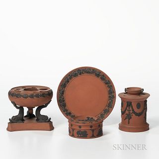 Four Wedgwood Rosso Antico Items, England, 19th century, each with applied black basalt relief, a circular box and cover with zodiac sy