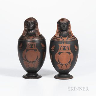 Pair of Encaustic Decorated Black Basalt Canopic Jars, England, 18th/19th century, with affixed covers, iron red motifs, unmarked, ht.
