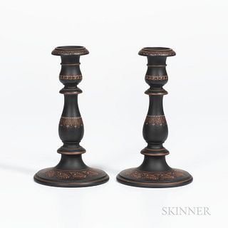 Pair of Wedgwood Encaustic Decorated Black Basalt Candlesticks, England, early 19th century, iron red and white with bands of foliage,