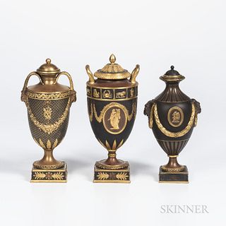 Three Wedgwood Gilded and Bronzed Black Basalt Vases with Covers, England, c. 1885, one with zodiac band above oval classical medallion
