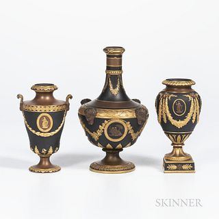 Three Wedgwood Gilded and Bronzed Black Basalt Vases, England, c. 1885, a barber bottle, the neck with floral festoons terminating at r