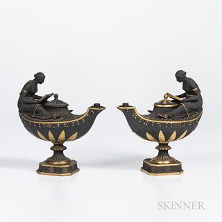 Two Wedgwood Gilded and Bronzed Black Basalt Oil Lamps and Covers, England, c. 1885, each oval, with fluted neck, oak leaf border and a