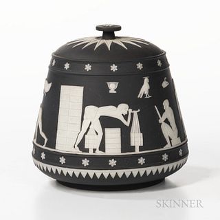 Wedgwood Black Jasper Dip Tobacco Jar and Cover, England, 20th century, tapering cylindrical shape with applied white stylized Egyptian