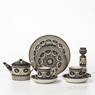Six Wedgwood Black Jasper Dip Items, England, 19th century, each with applied white classical decoration, including two trophy plates,