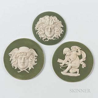 Three Wedgwood Green Jasper Dip Plaques, England, 19th century, each roundel with applied white relief, one each depicting Cupid String