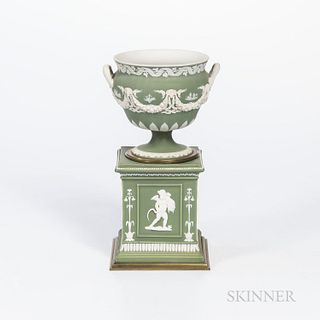 Wedgwood Green Jasper Dip Urn on Stand, England, 19th century, applied white classical relief, the urn with figures and trophies within
