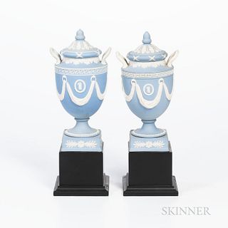Two Wedgwood Solid Light Blue Jasper Vases and Covers, England, 19th century, each with acorn finial and applied white classical medall