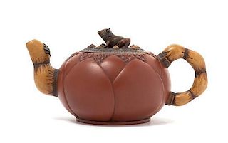 A Yixing Pottery Teapot Height 3 5/8 x width over handle 7 inches.
