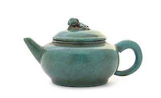 A Green Glazed Yixing Pottery Teapot Height 3 5/8 x width over handle 7 7/8 inches.