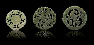 * Three Pierce Carved Jade Circular Pendants Diameter of largest 2 1/2 inches.