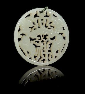 * A Carved Celadon Jade Circular Pendant Diameter 2 1/4 inches.