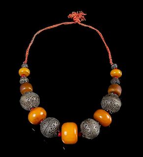 An Amber and Metal Beaded Necklace Length overall 14 1/2 inches.