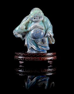 A Carved Opal Figure of Mile Height overall 4 3/4 inches.