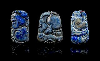 * A Group of Three Carved Lapis Lazuli Pendants Length of first 2 5/8 inches.