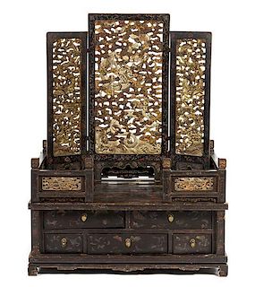 * A Chinese Parcel Gilt and Black Lacquered Wood Dresser POSSIBLY 19TH CENTURY Height 39 1/4 x width 19 1/4 inches.