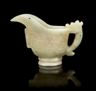 * A Carved Jade Libation Cup Length overall 2 5/8 inches.