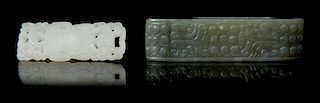 * Two Carved Jade Sword Slides Length of larger 2 3/4 inches.