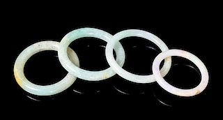 Four Jadeite Bangles Diameter overall of largest 2 7/8 inches.