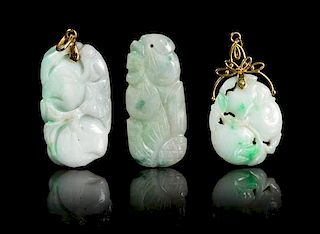 * Three Carved Jadeite Pendants Height of largest 1 3/4 inches.