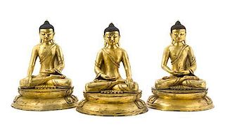 A Set of Three Gilt Bronze Figures of Buddha Height of set 17 inches.