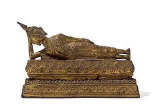 A Thai Gilt Bronze Figure of a Reclining Buddha Height 6 1/4 inches.