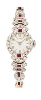 A 9CT RUBY AND DIAMOND COCKTAIL WATCH, the round white dial