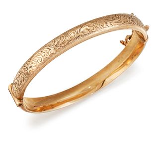 A 9CT GOLD BANGLE, the hinged bangle with bright cut engrav