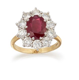 AN 18CT RUBY AND DIAMOND CLUSTER RING, the oval ruby, appro
