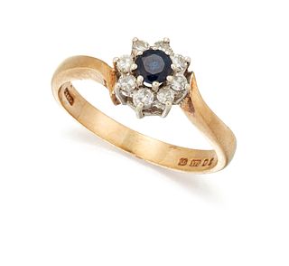 A 9 CARAT GOLD SAPPHIRE AND DIAMOND CLUSTER RING, the round
