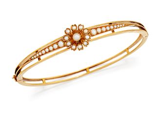 A VICTORIAN SEED PEARL BANGLE, the central seed pearl set f