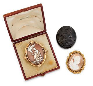 TWO CAMEO BROOCHES AND A JET CAMEO, the first an oval shell