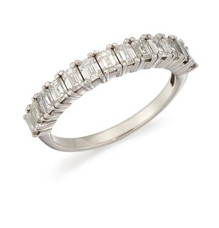 A HALF HOOP ETERNITY RING, the upper half set with emerald 