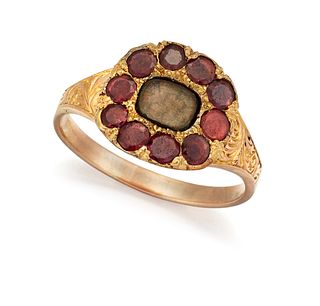 A VICTORIAN GARNET AND HAIRWORK MEMORIAL RING, the central 