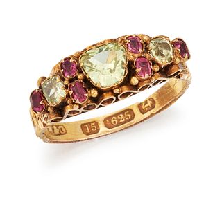 A 15 CARAT GOLD PERIDOT AND RUBY RING, the central off-oval