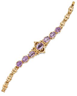 A VICTORIAN AMETHYST BRACELET, the central oval amethyst, c