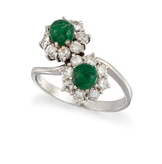 AN EMERALD AND DIAMOND RING
 Composed of a pair of crossove