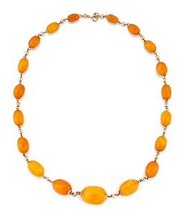 AN AMBER BEAD NECKLACE, the graduated oval beads approx. 6.