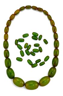 A GREEN 'BAKELITE' BEAD NECKLACE,?the oval beads, between a