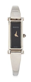 A LADY'S STEEL GUCCI BANGLE WATCH. Rectangular black dial s