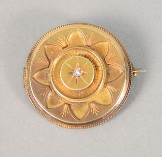 14K yellow gold brooch stamped 14K, round shaped with 1 rose cut diamond, approximately 0.3 ct.