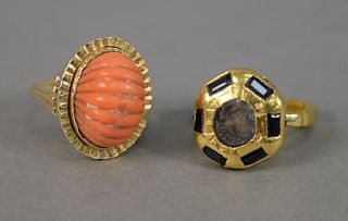 Two 14K yellow gold rings, one stamped 14K, set with one oval fluted carved coral, 9.9 gr., size 6 along with 18K yellow gold ring, tested as 18K, cen