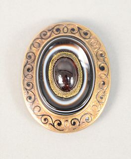 14K yellow gold Victorian mourning brooch tested as 14K, amethyst cabochon in center and hair locket, weighs 18.9 dwt.